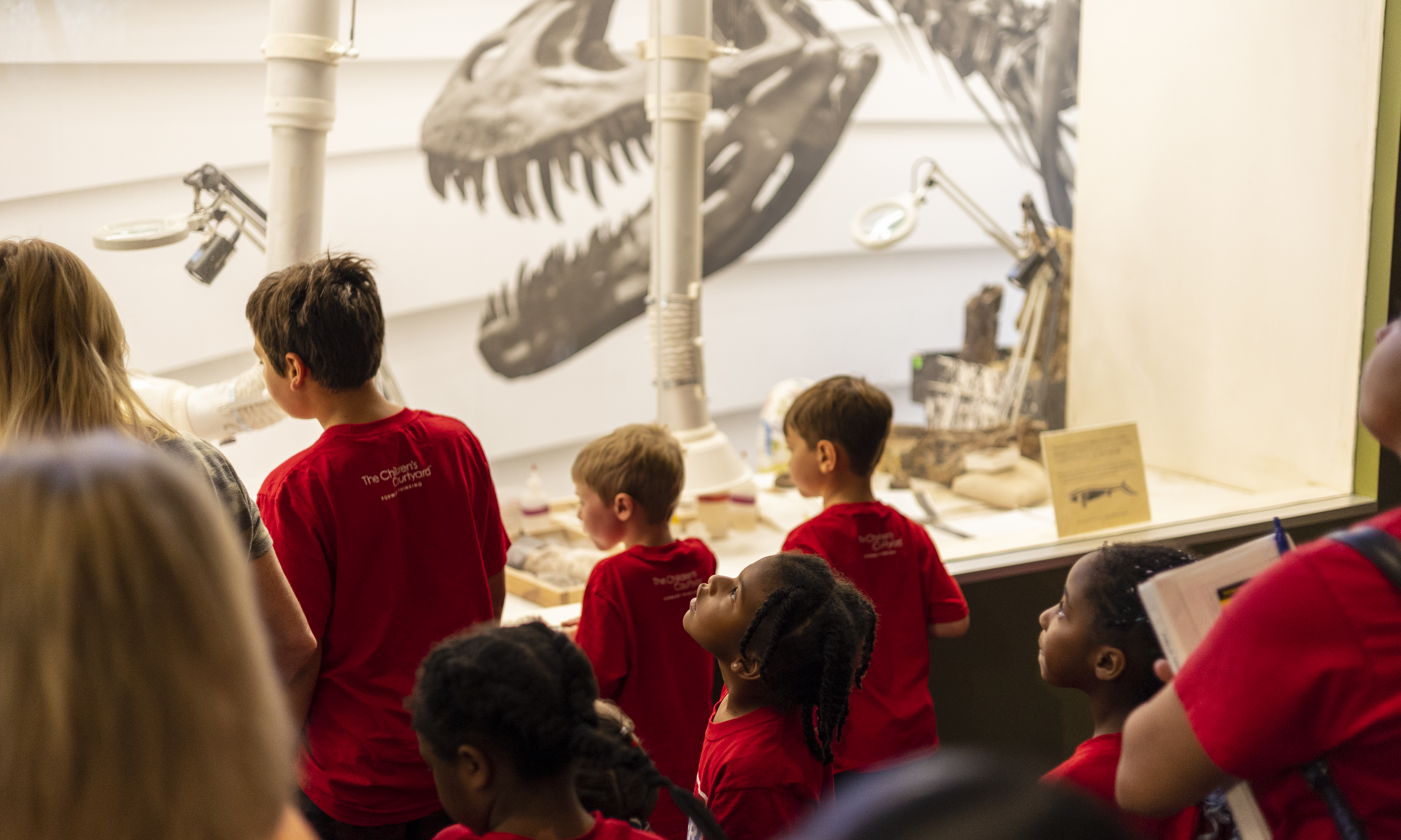 Kids looking through Paleo Lab window