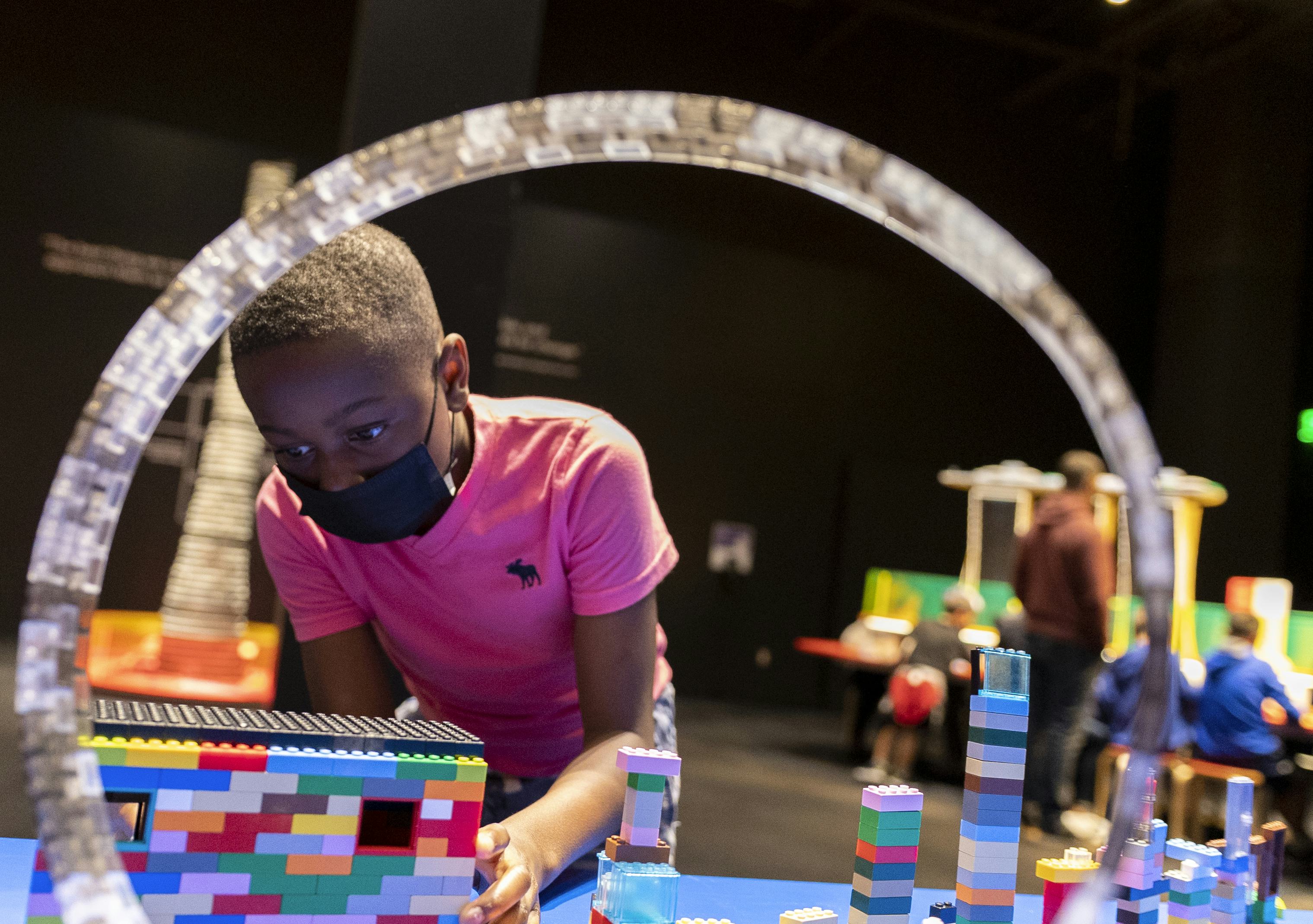 Child playing with Lego Bricks at the exhibit
