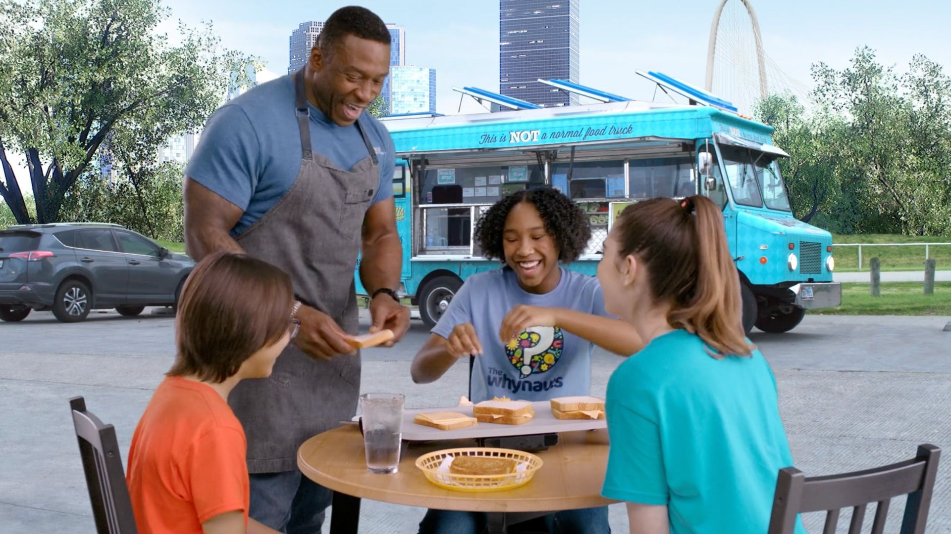 People eating sandwiches from food truck