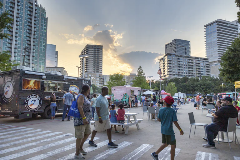Groups of people in front of food trucks
