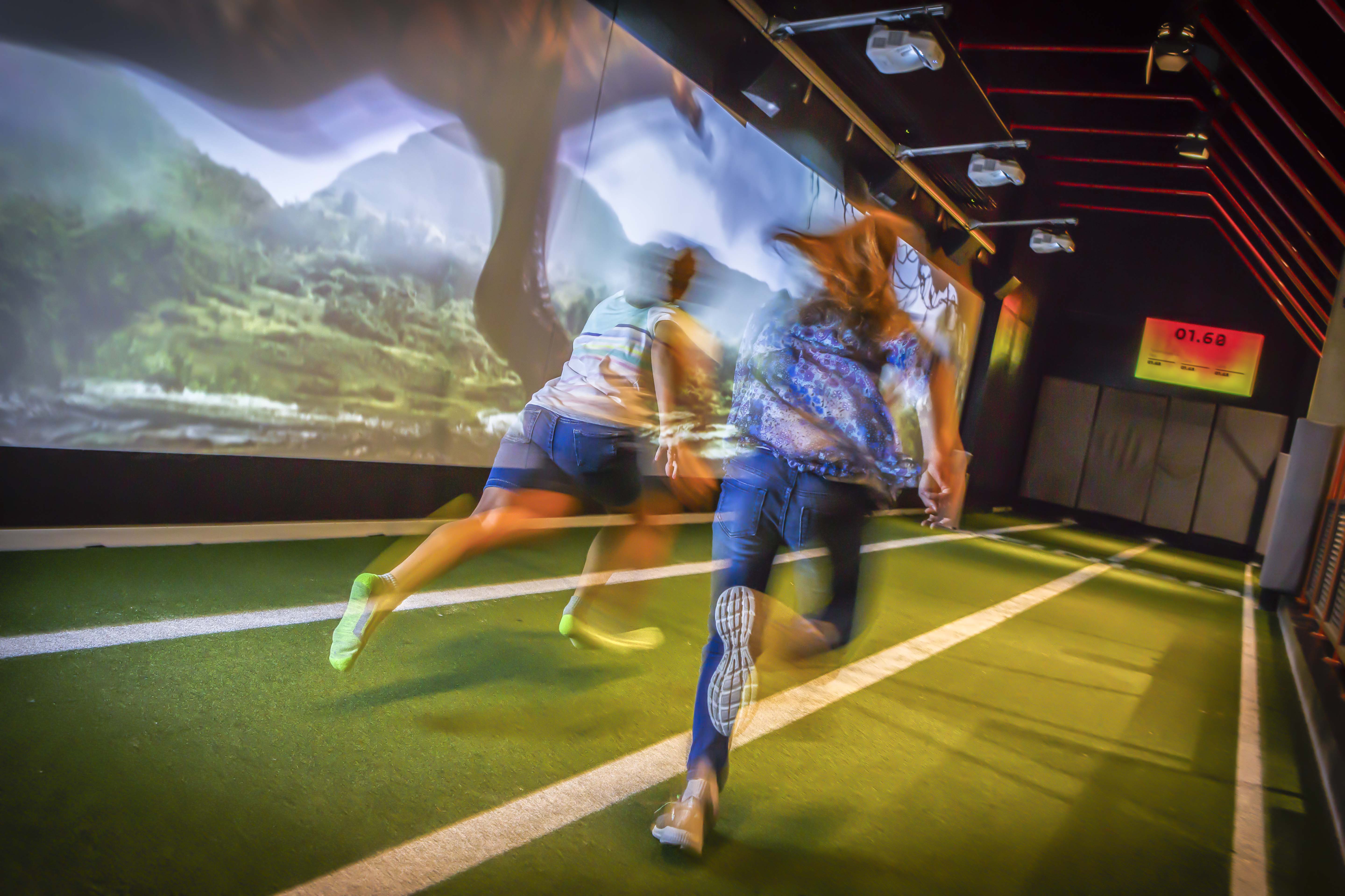 Two people running a race against a cheetah.