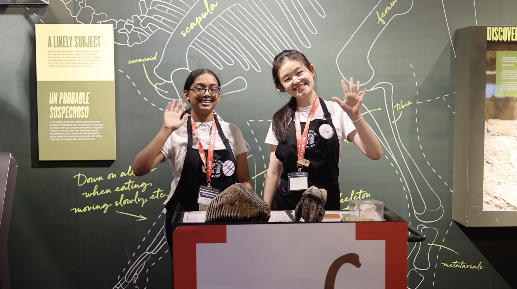 teenage girls waving