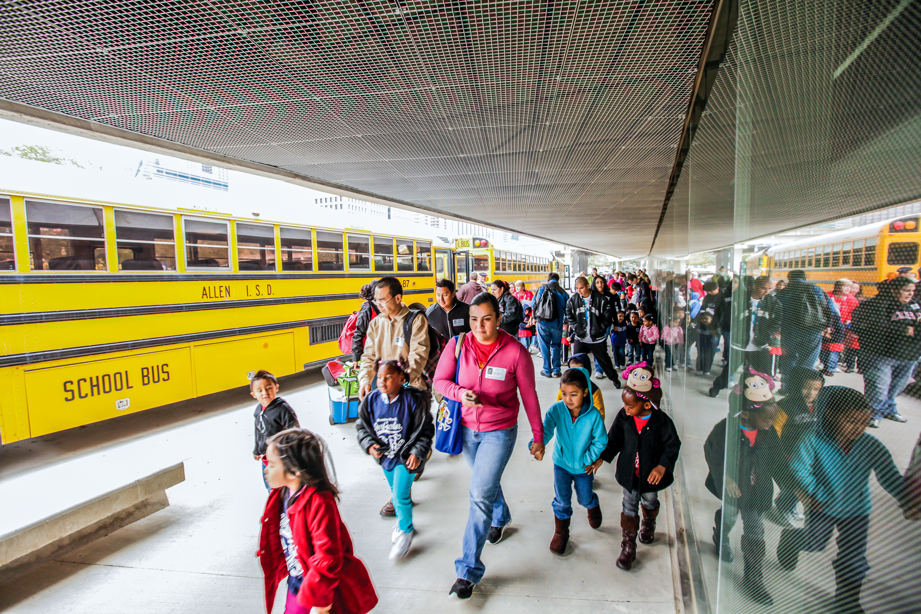 Group of students at the Perot outside a school bus