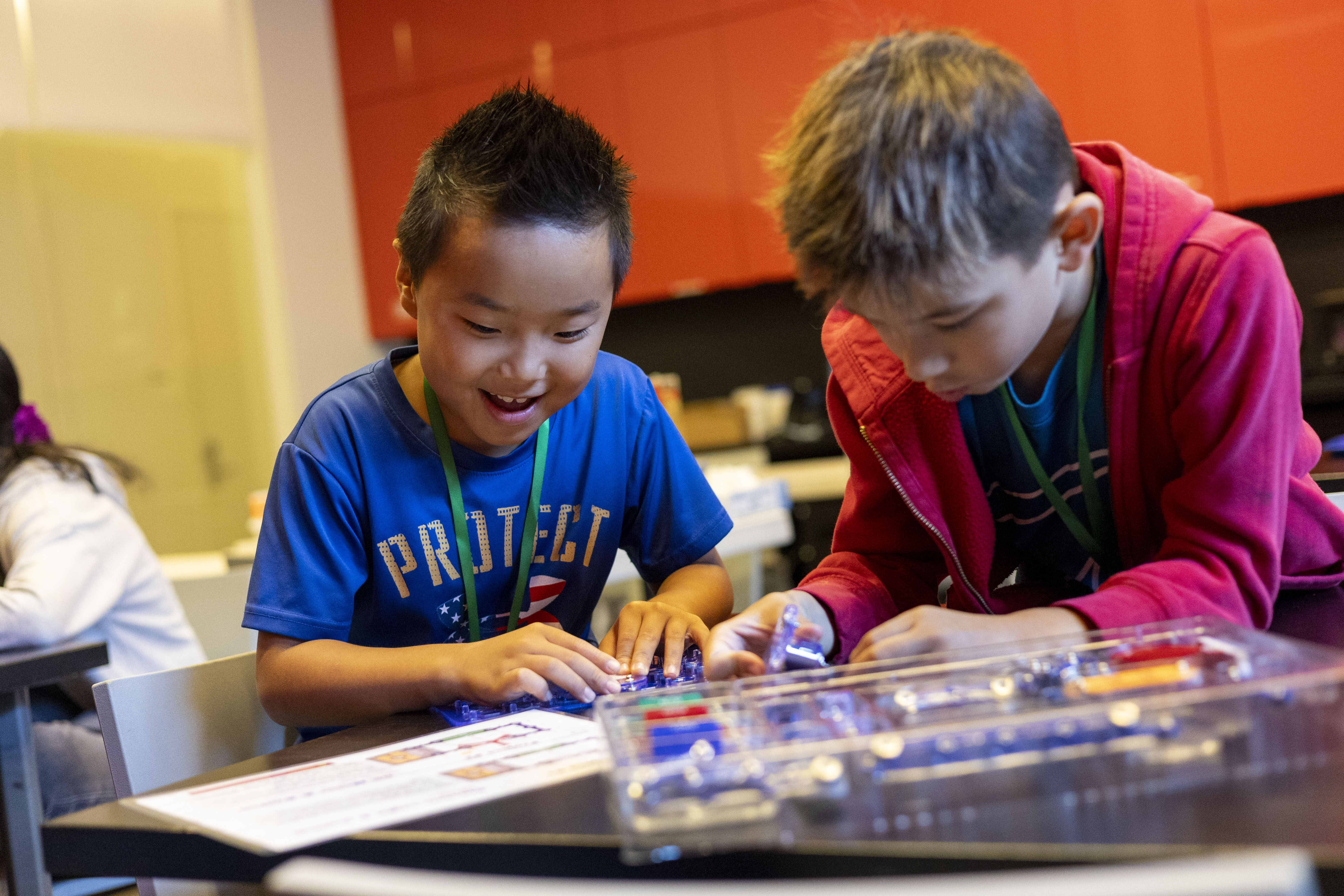 kids performing electrical lab at camp